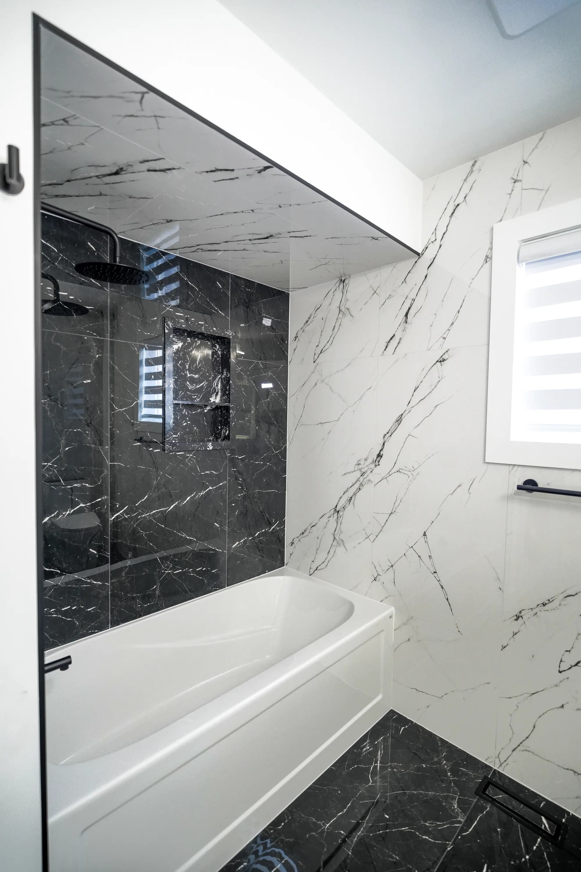 Monochrome marble bathroom with black fixtures