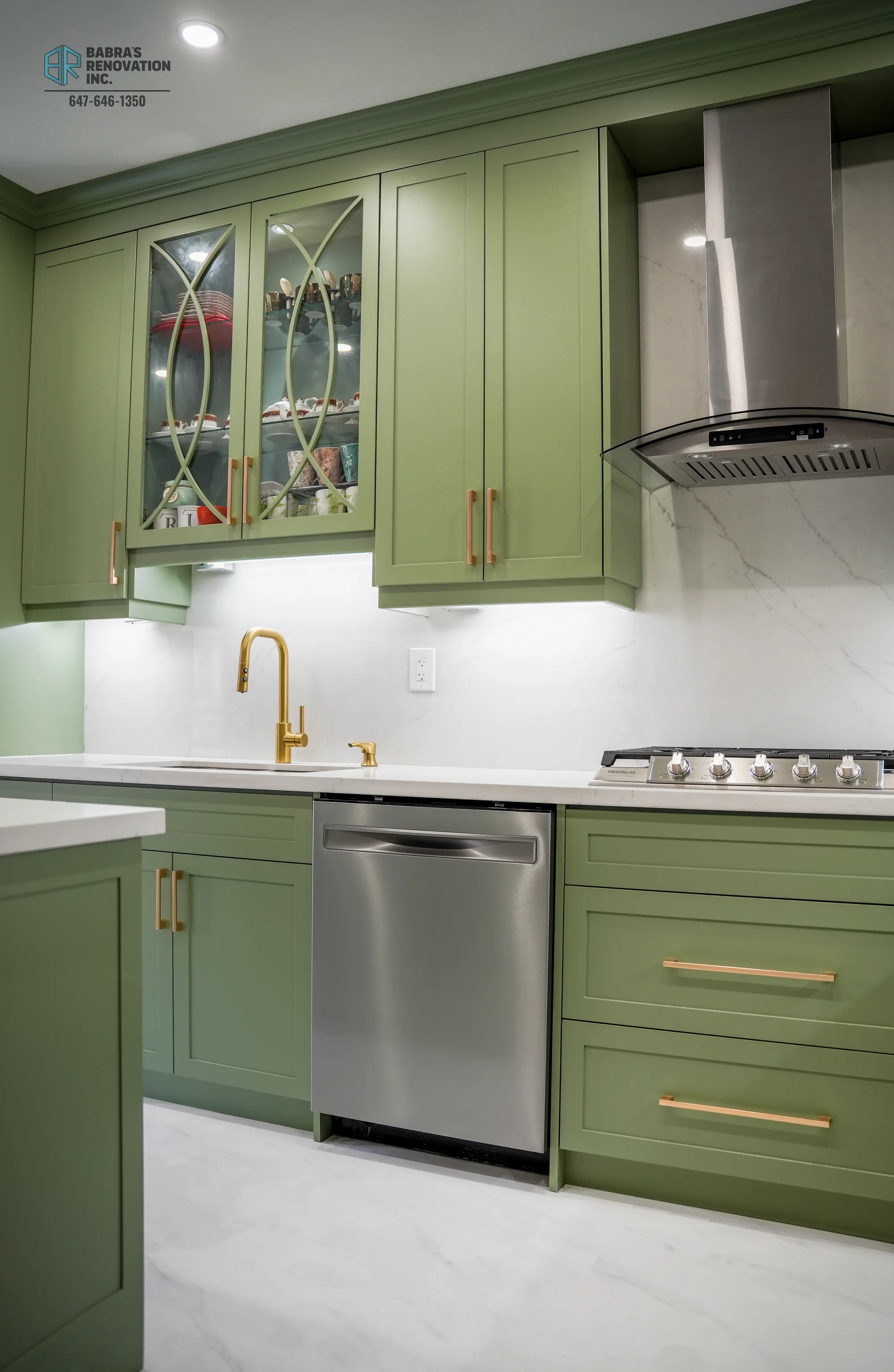 Kitchen sink area with gold faucet and under-cabinet lighting