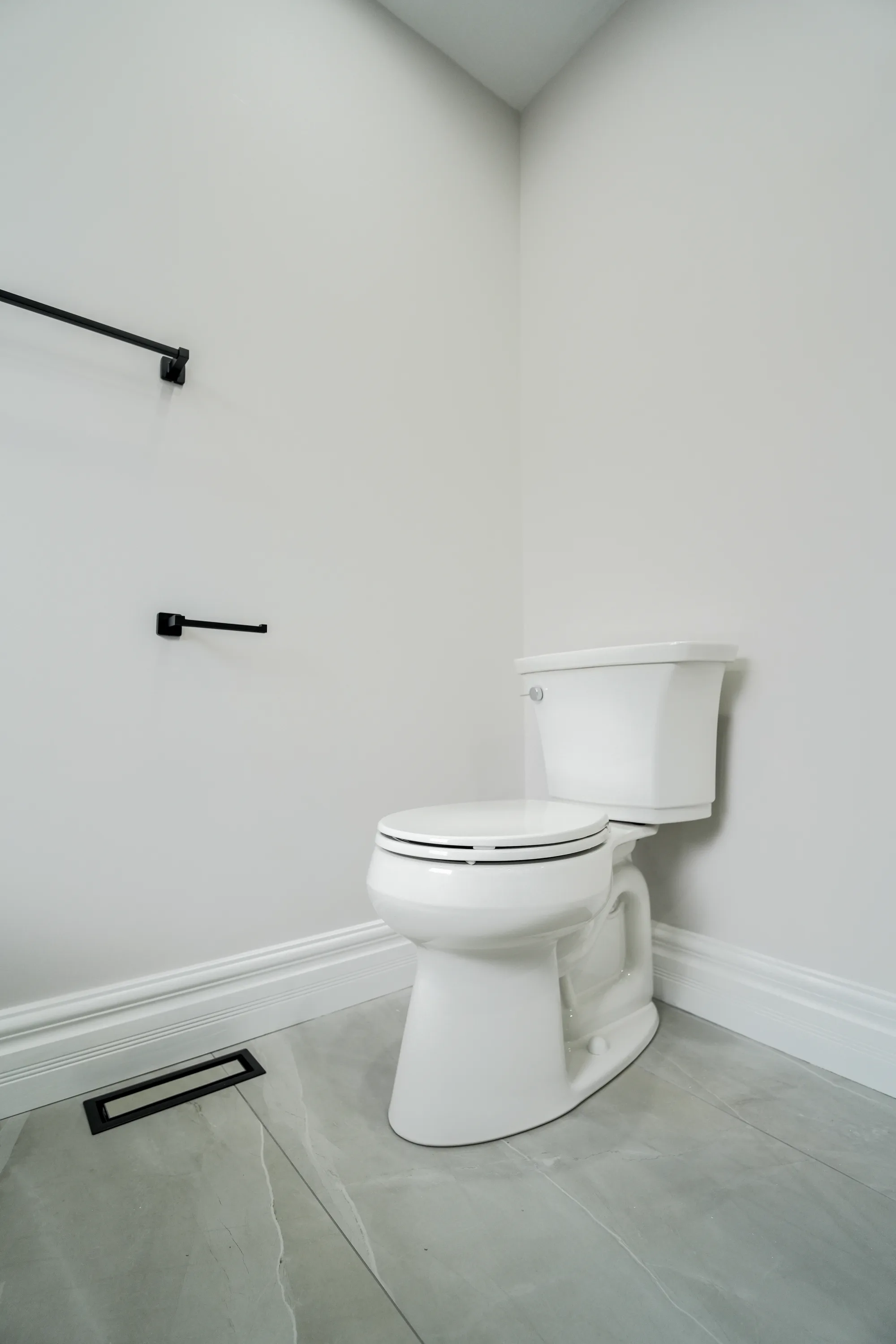 Compact bathroom with modern toilet and matte black accessories