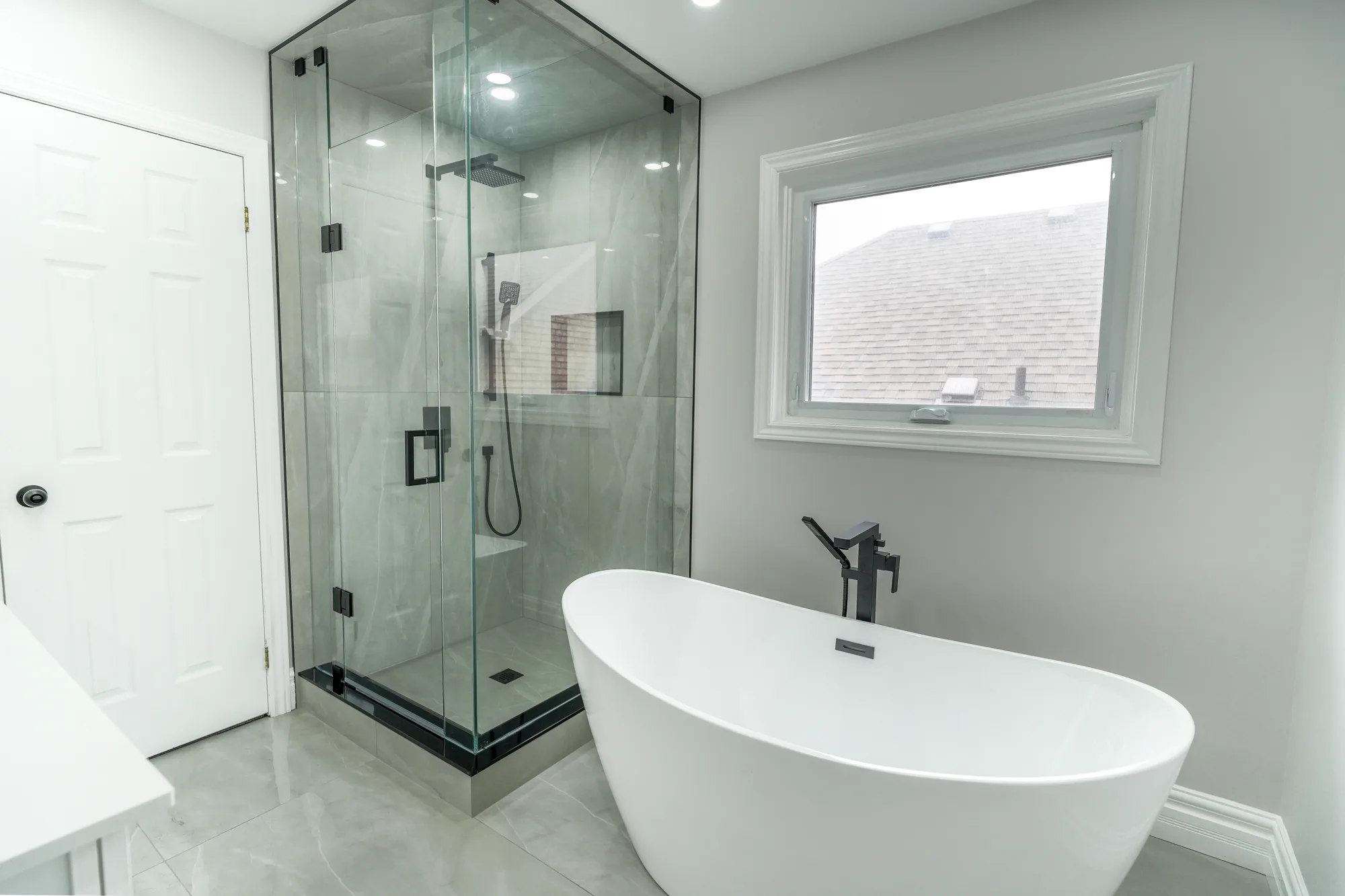 Modern ensuite with freestanding tub and glass walk-in shower